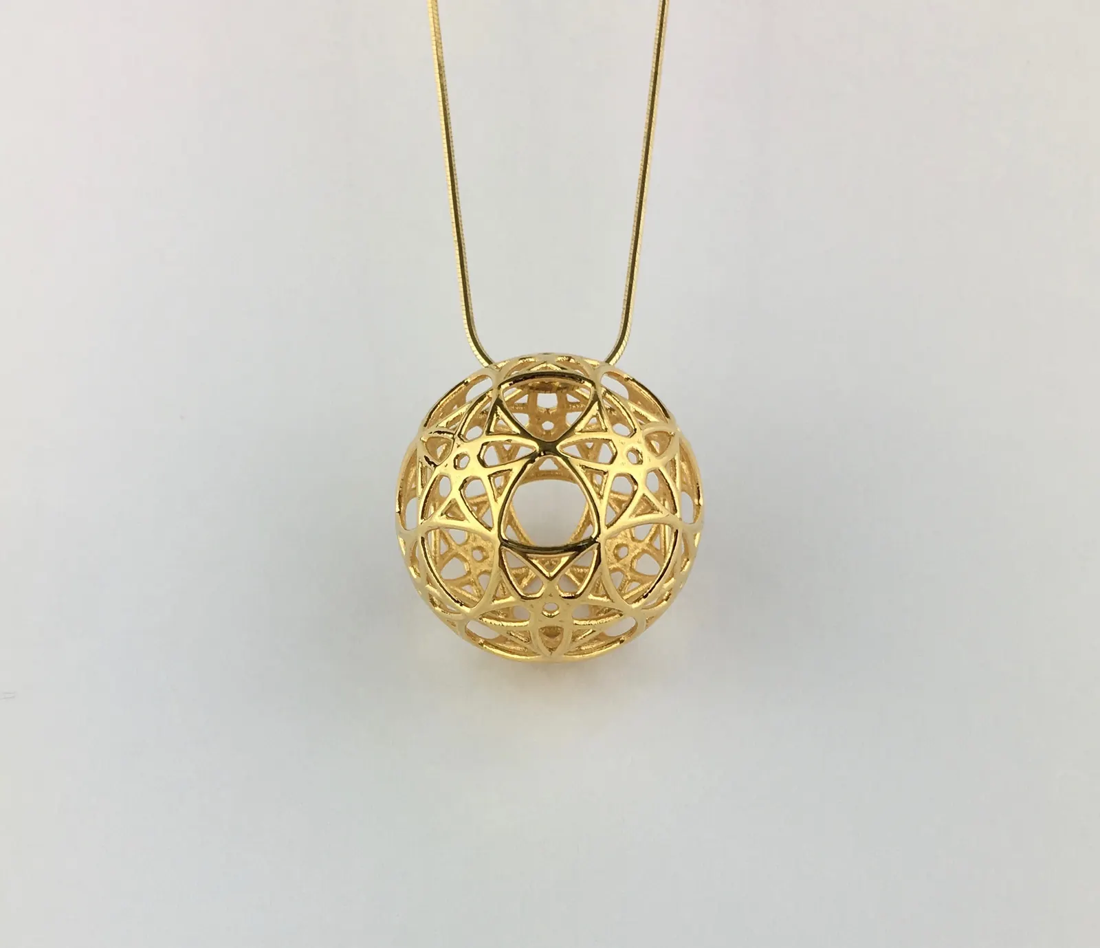 14k gold plated AllSphyr pendant hanging from a fine gold chain