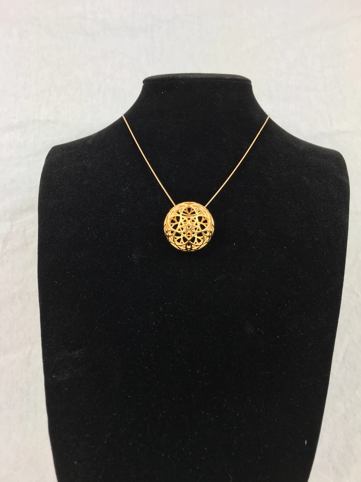 14k gold plated AllSphyr pendant on a black necklace bust, viewed from the front