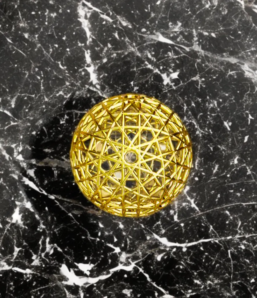 Resonance Sphyr gold sphere viewed from above on black marble
