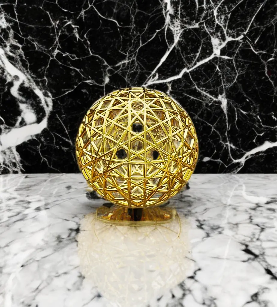 Resonance Sphyr gold sphere on white and black marble