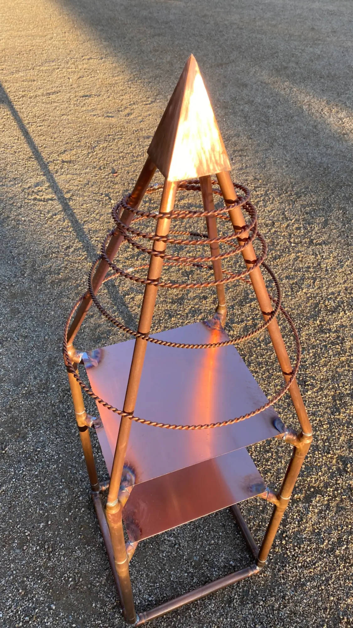 Detail of the Pyramid Altar's copper pyramid top, coiled copper wire, and polished copper shelf
