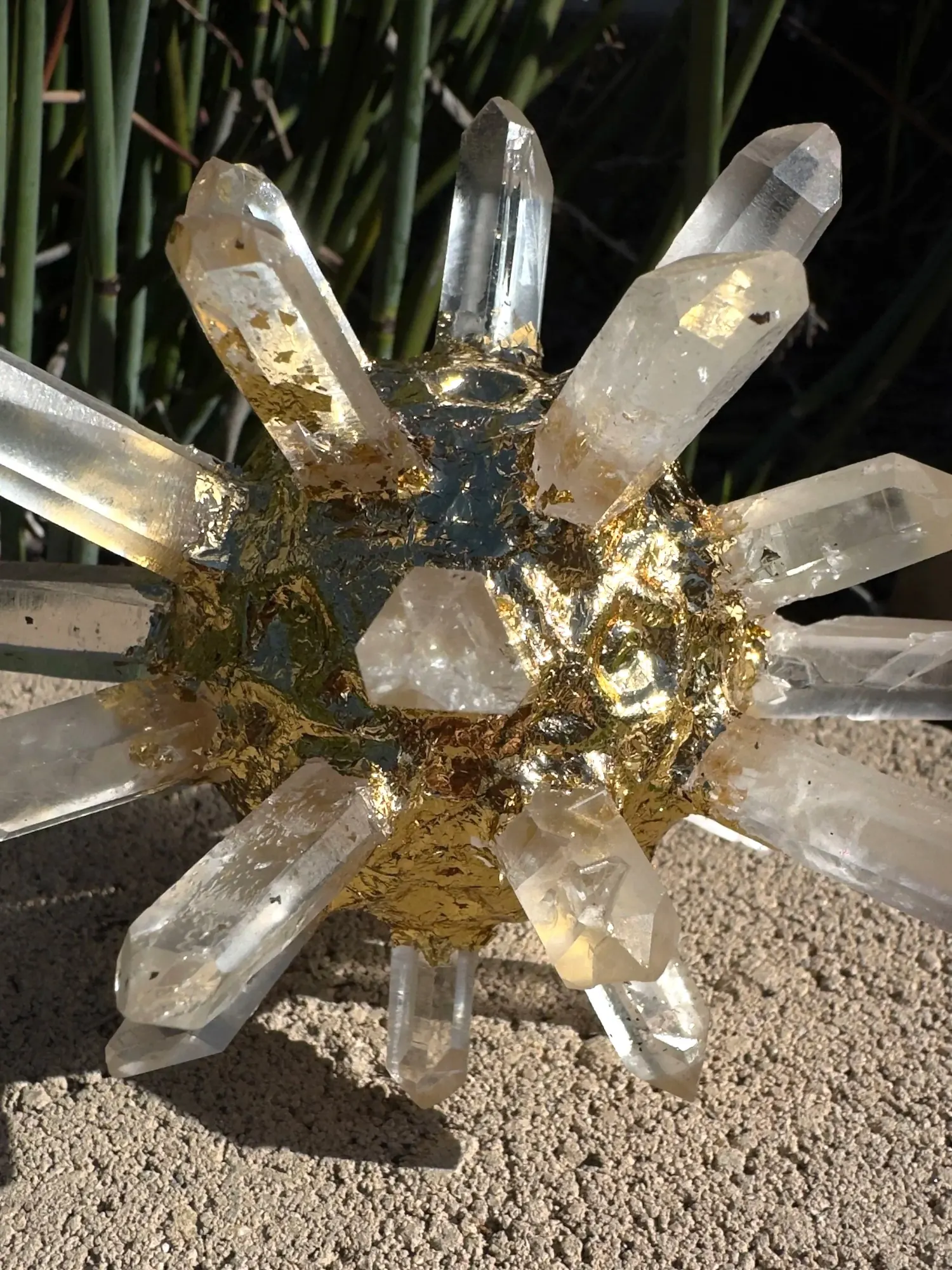 Quartz Crystal AllSphyr sculpture in sunlight showing the gilded center and radiating crystals