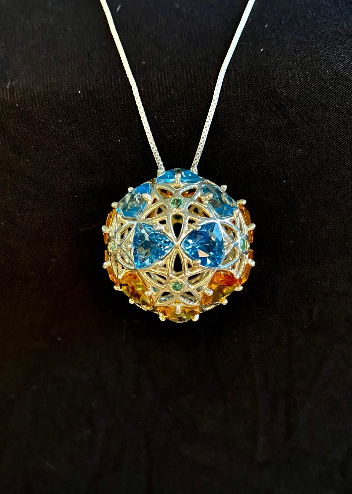 GemSphyr pendant with blue topaz, citrine, and emerald stones, close view