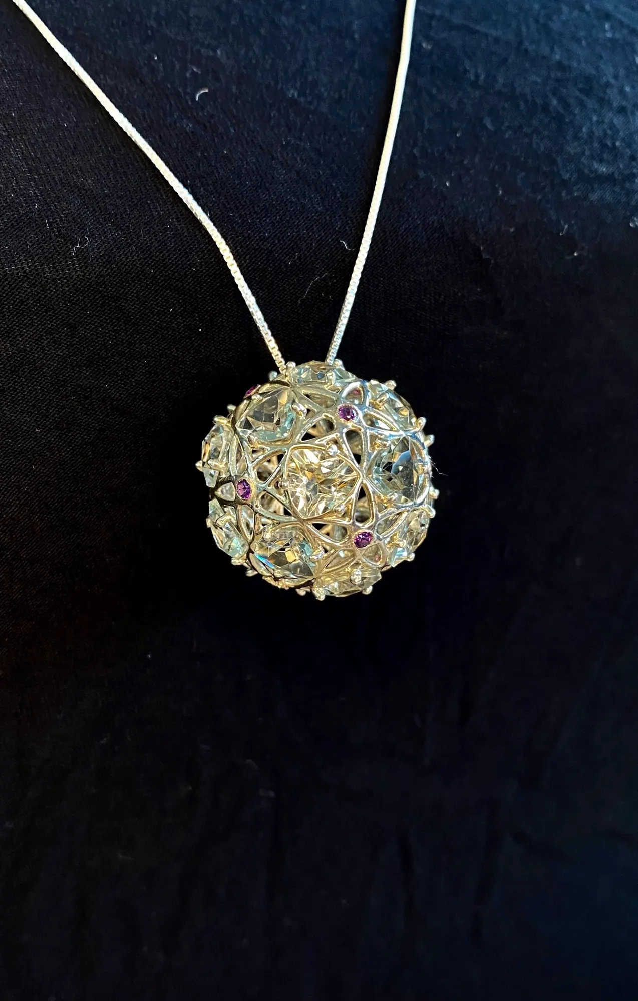 GemSphyr pendant with green quartz and amethyst stones, angled view